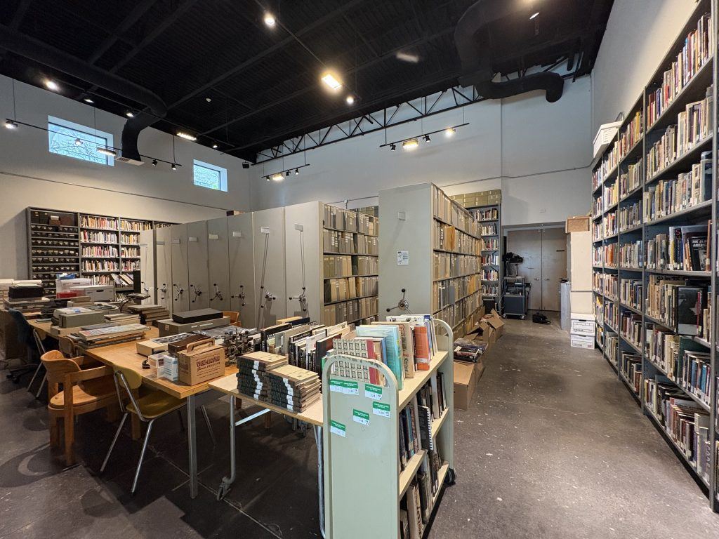 Room filled with shelves of books.