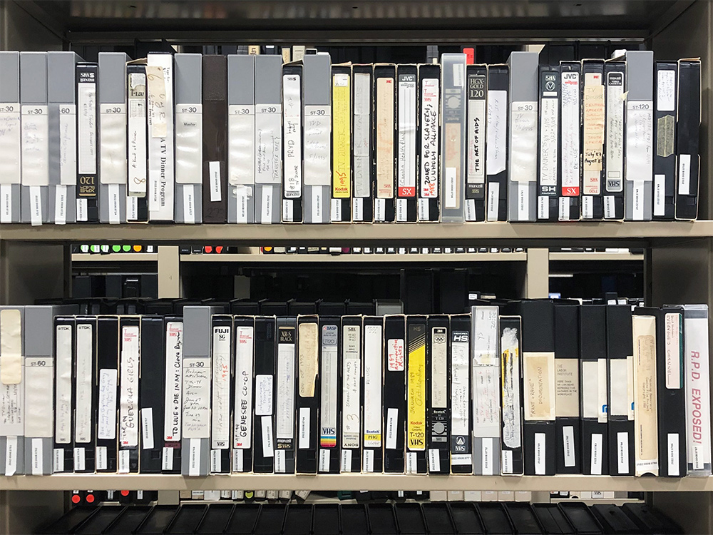 Two rows of tapes on a shelf.