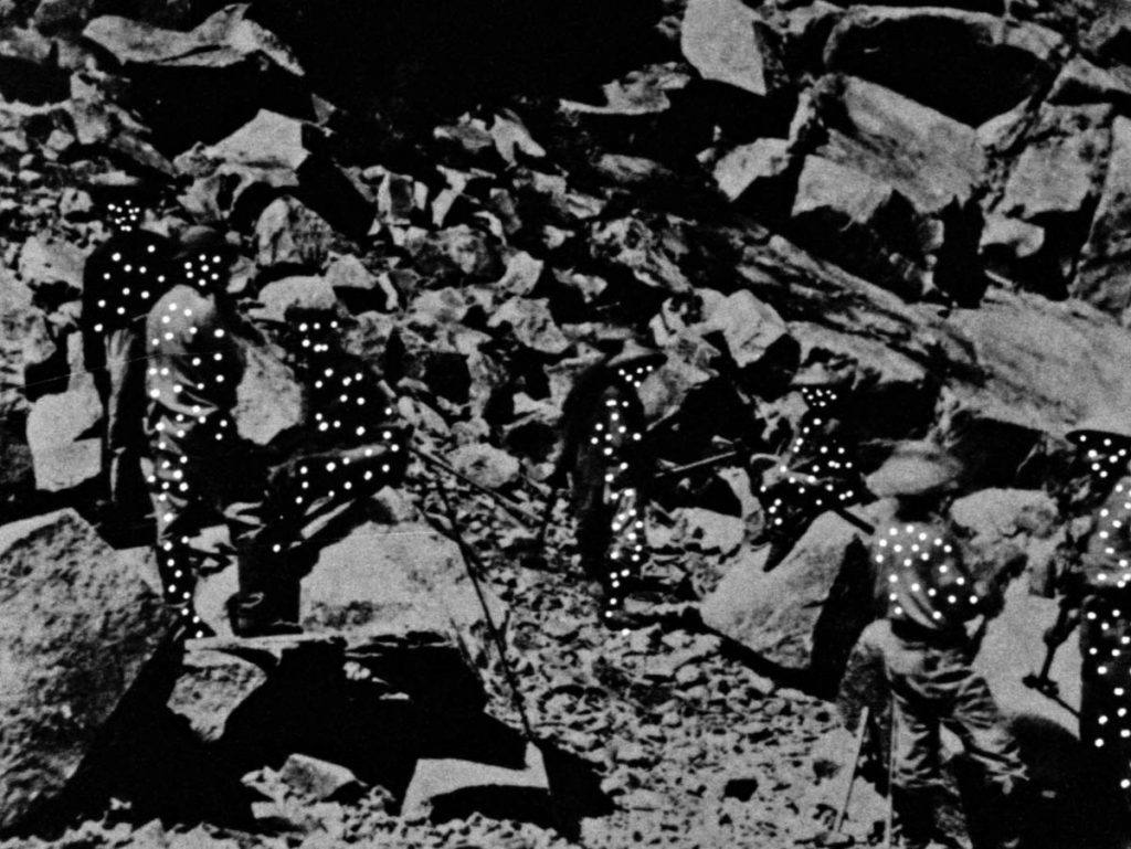 Black and white film still of rocks.
