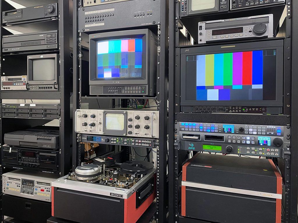 Three AV racks with video equipment.