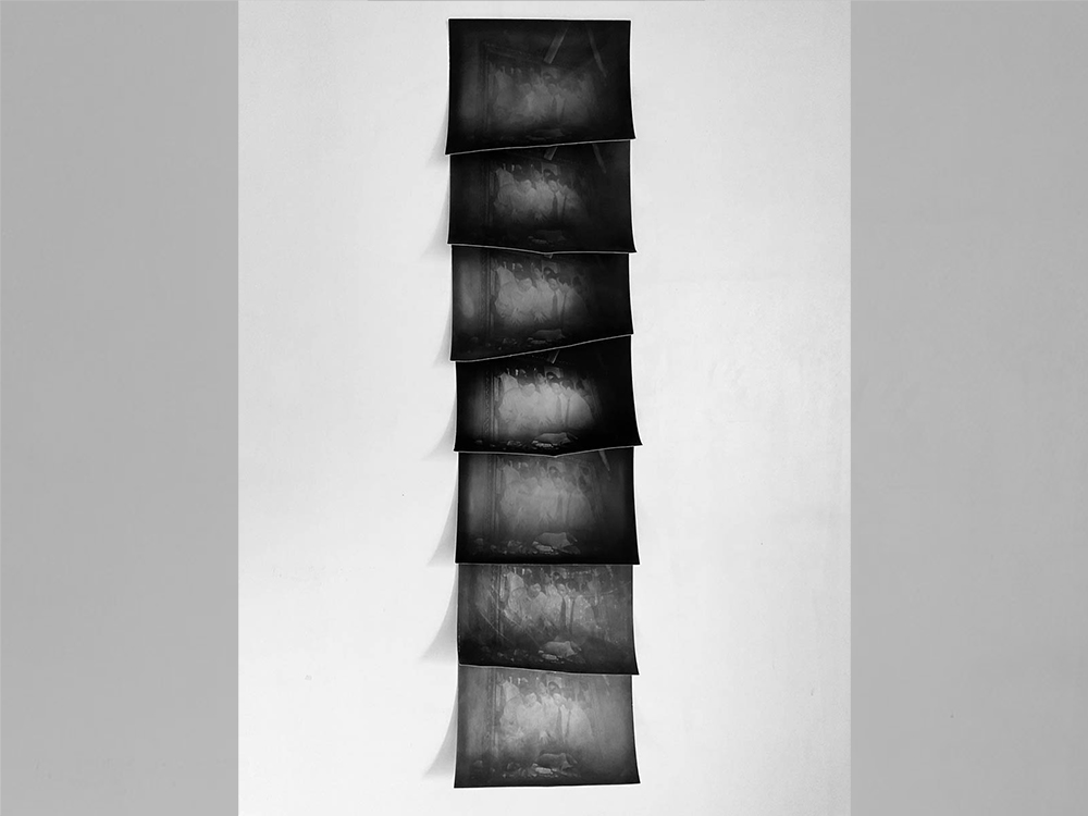A vertical wall hanging of black and white, abstract photographic images.