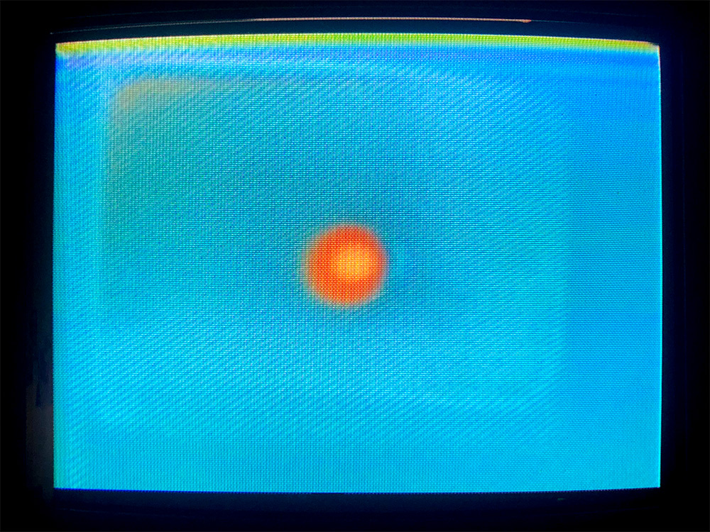 A blue, glowing TV monitor with an orange dot in the middle.
