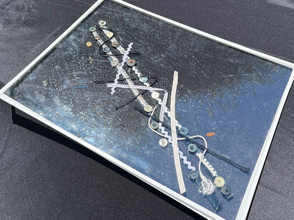 Two film strands on plexiglass with objects on them