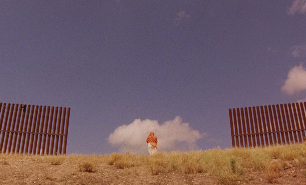 A zoomed out image of a person far in the distance against a blue sky.